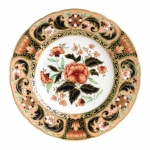 Imari Accent Derby Pink Camellias Accent Plate Part of a larger collection of Imari inspired Accent plates and coordinating cups and saucers, the Derby Pink Camellias Plate displays a peach and orange color palette of flora and fauna finished with hand applied 22 carat gold. 