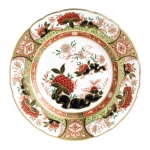 Imari Accent Golden Peony Accent Plate Part of a larger collection of Imari inspired Accent plates and coordinating cups and saucers, the Golden Peony Plate displays a deep red color palette of flora and fauna finished with hand applied 22 carat gold. 