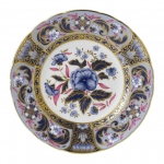Imari Accent Blue Camellias Accent Plate Part of a larger collection of Imari inspired Accent plates and coordinating cups and saucers, the Blue Camellias Plate displays a fresh blue and purple color palette of flora and fauna finished with hand applied 22 carat gold. 