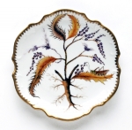 Thistle Bread and Butter Plate Discerning hostesses and porcelain enthusiasts have long coveted Anna Weatherley\'s exquisite hand-painted porcelain tableware featuring butterflies, bugs and botanical images.  Anna Weatherley was born in Budapest, Hungary.  Her artistic nature was nurtured by an environment filled with beautiful architecture, furniture, marble, ironwork and artwork of her native country.  

Her father\'s death during the war left Anna and her mother destitute.  They eventually fled communist controlled Hungary for Australia, where Anna studied design and painting.  A trip to India resulted in Anna\'s falling in love with Indian handmade textiles.  By the Late 1970\'s her hand-painted and embroidered chiffon dresses were sold at Saks, Bloomingdales and Nordstroms, as well as privately to Elizabeth Taylor, Lady Bird Johnson, and the late Pamela Harrimon.  

When the end of the Cold War reopened Budapest, Anna returned to her beloved home city.  Her interests had turned to the works of the realistic 16th, 17th and 18th century botanical artists, and in Hungary she found artists talented enough to re-create the highly detailed, realistic style of these Romantic periods.  Anna breathed new life into Hungary\'s two-centuries-old tradition of hand-painted porcelain.  Anna\'s creative vision had again taken top retailers and consumers by storm by the late 1990\'s.  The editor of Vogue commissioned Anna Weatherly cachepots as a gift for England\'s late Princess Diane.  

As she ventures into the new century, Anna Weatherley again has ventured into new territory, offering consumers beautiful framed paintings on porcelain: butterflies, flowers and leaves, as well as watercolors on parchment paper.  These also have been enthusiastically received by a public which can never seem to get enough of Anna Weatherly.