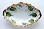 Ivy Garland  Open Oval Vegetable Bowl The rich gold band enhanced by green ivy garland dramatically frames a body of pure white.  Winged wonders abound.  Formal beauty remains a timeless classic.